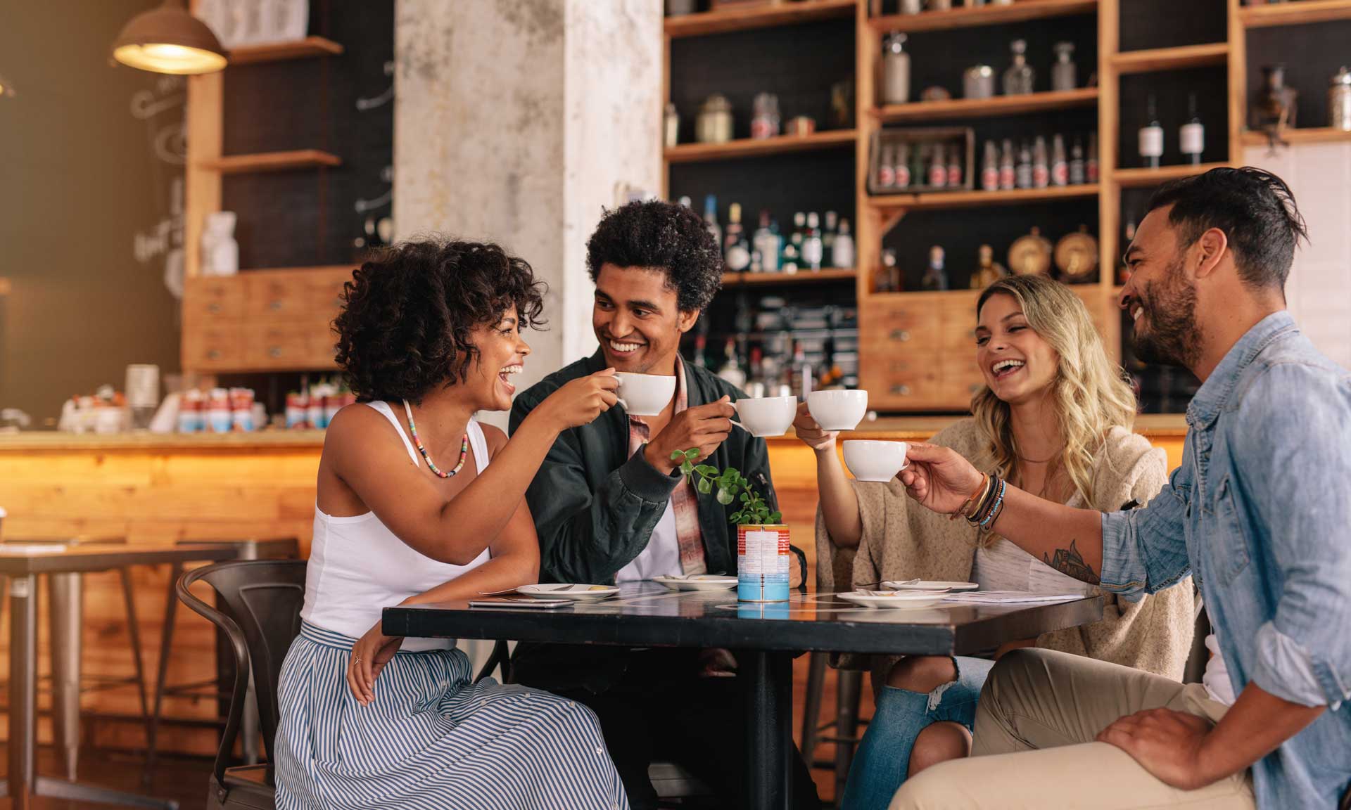 Group of friends at cafe having coffee together