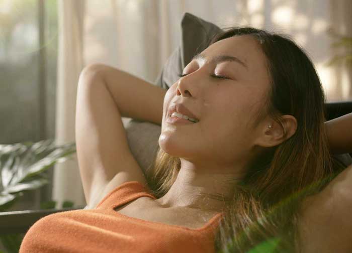 Asian woman resting breathing fresh air feeling mental balance e